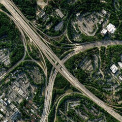 Aerial View of Urban Highway Interchange Surrounded by Greenery and Residential Areas on a Bright Day