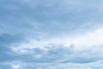 Overcast sky filled with layers of soft muted blue and white stratocumulus clouds