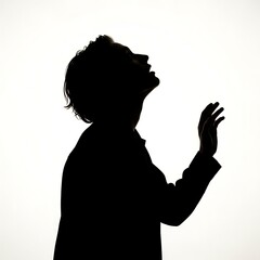 Silhouette of a person looking up with an open hand gesture against a bright white background.