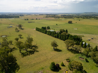Aerial view expansive Australian farmland scattered trees rural homesteads