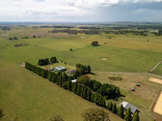 Aerial view expansive Australian farmland scattered trees rural homesteads