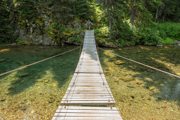 Backpacker Begins To Cross The Foot Of Elizabeth Lake Suspension Bridge
