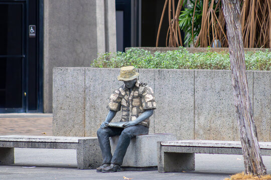 What's Next, by sculptor Jodi Endicott, also known as The Man at the Bus Stop on Bishop Street, located in the financial district of downtown Honolulu, Hawaii. Image taken February 26, 2024