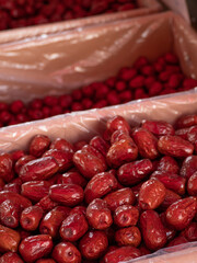 Deep red jujubes in two cardboard boxes