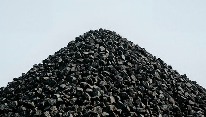 Pile of dark coal rocks arranged in a rough pyramid