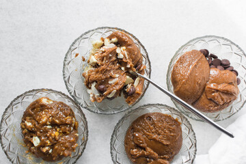 Overhead view of giant chocolate chip cookie dough in glass bowls, chocolate chip cookie dough in a small mixing bowl