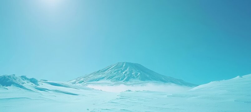 Breathtaking snow capped mountain peak against a clear blue sky  a winter sports adventure awaits