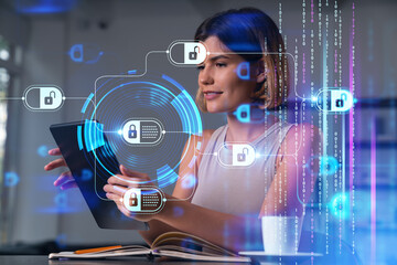 Smiling businesswoman in casual wear holding tablet device touching it at office workplace. Concept of distant work, business education, information technology.Blockchain hologram