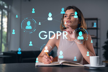 Smiling woman in casual wear taking notes in notebook at office workplace with coffee cup. Concept of distant business education, information technology, dreaming, thinking. data security drawings