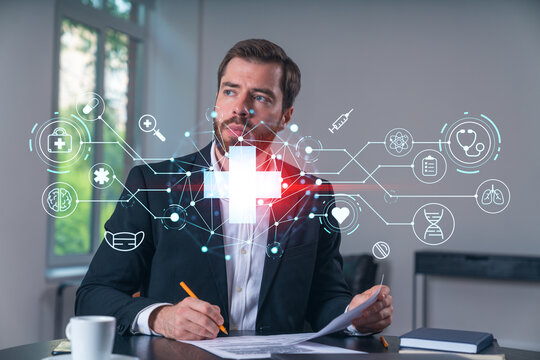 Calm businessman in formal wear signing contract at office workplace with coffee cup, laptop and notebook. Concept of successful deal, agreement, partnership, documents. Medical healthcare icons.