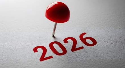 Red pin marking the year 2026 on a metallic surface