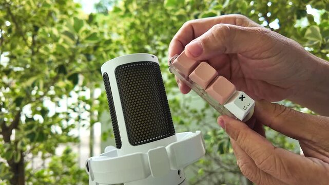 ASMR clicking sound. Hands pressing mechanical keyboard switch near mic