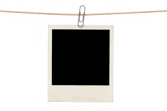 Blank instant frame hanging on a rope with paperclip, creating a vintage memory display on transparent background