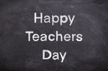 A chalkboard with the words Happy Teachers Day written on it