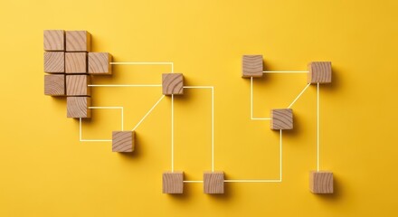 Wooden blocks form a network diagram on a bright yellow background.