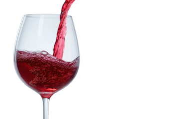 Red wine being poured into an empty elegant glass against a transparent background with copy space available for advertising