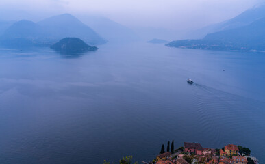 Misty Lake Como panoramic view tranquil Italian mountain lake landscape soft blue water ferry boat wake over peaceful alpine scenery romantic Europe travel photography dream escape serene horizon