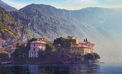 Colorful Italian lakeside village on Lake Como with pastel houses mountains and misty morning light romantic travel photography Europe destination for nature lovers and landscape wall art prints