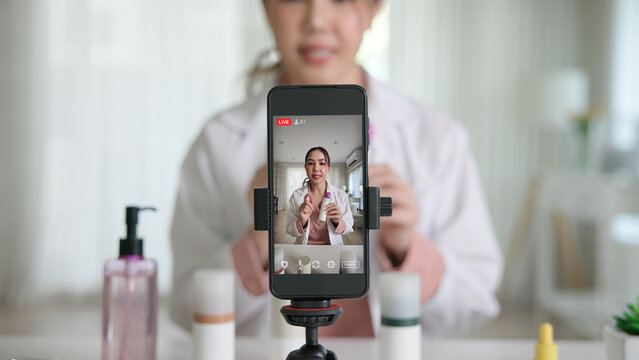 Asia woman people anti aging expert modern health vlogger live advice talk selfie video mobile phone camera. Online digital seller asian small SME store shop owner side hustle filming sell skin care.