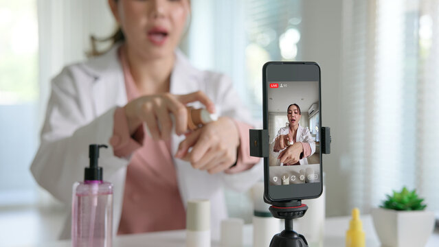 Asia woman people anti aging expert modern health vlogger live advice talk selfie video mobile phone camera. Online digital seller asian small SME store shop owner side hustle filming sell skin care.