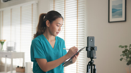 Young adult woman asia Gen Z people anti aging expert modern nurse live talk prepare video selfie camera on mobile phone app mental health care Online side hustle digital virtual asian vlogger filming