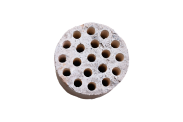 Round ceramic kiln burner with multiple small holes, isolated on white background.