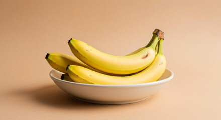 Fresh ripe bananas in a white bowl showcasing healthy, organic tropical fruit with vibrant yellow color, perfect for nutritious snacking, breakfast, and diet