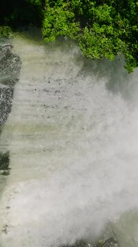 Vertical view of Hikong Alo watetrfall in Lake Sebu with green trees. Mindanao, Philippines. Slow motion.