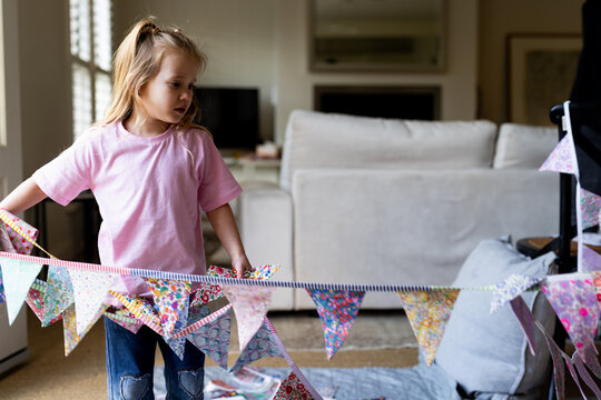 Young girl setting up the buntings around makeshift tent