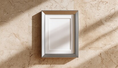 Overhead shot of a blank, rectangular picture frame, casting shadows on a marble surface