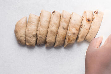 Process of making hot cross buns, hot cross bun dough portioned into smaller pieces