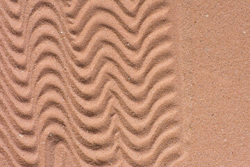close up view of textured brown sand background, beautiful sand texture, overhead view of zen pattern drawn in brown sand, Top view of fine grain texture