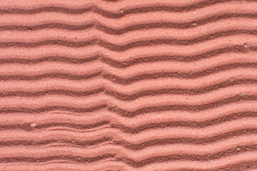 close up view of textured coral sand background, beautiful sand texture, overhead view of zen pattern drawn in coral sand, Top view of fine grain texture