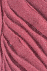 close up view of textured pink sand background, beautiful sand texture, overhead view of zen pattern drawn in pink sand, Top view of fine grain texture