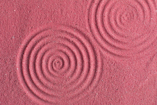 close up view of textured pink sand background, beautiful sand texture, overhead view of zen pattern drawn in pink sand, Top view of fine grain texture