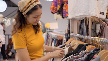 Young teen tourist Gen Z asia female choose look at zero waste eco go green buy second hand sale...