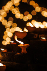 clay oil lamps lit along the brick walls at Jaeng Hua Rin and around the Chiang mai moat, their warm flames glowing softly at night during the Yi Peng festival