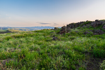 Ancient Volcanic Rocks With Distant Mountains