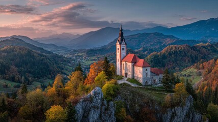 Fototapeta premium Church of st. Primoz surrounded by rolling green hills and scenic slovenian countryside under soft natural light