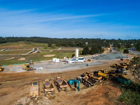 Machinery parked on Singleton Bypass worksite with view to new housing area with land for sale 