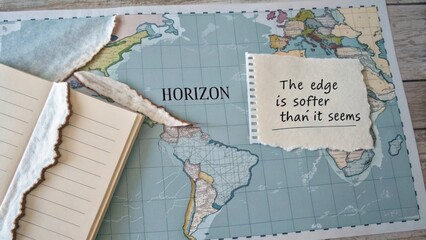 Vintage World Map with Soft Edges, Notepad, and Inspirational Quote on Natural Wooden Surface