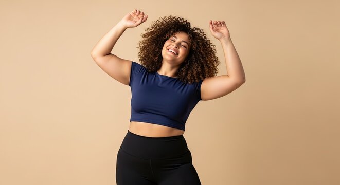Young Woman With Curly Hair Joyfully Dancing With Arms Raised Upward