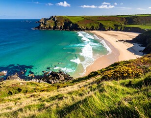 Aerial view of a stunning coastal scene. A sandy beach curves into crystal-clear turquoise waters. Cliffs and grassy hills surround