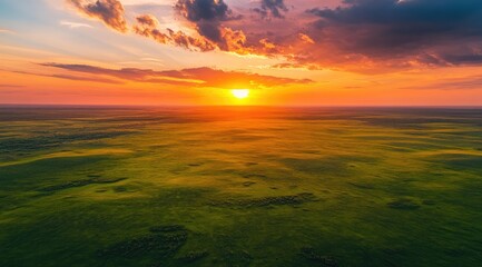Vast, vibrant sunset over a grassy plain