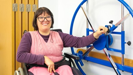 Woman smiling using shoulder wheel for rehabilitation therapy