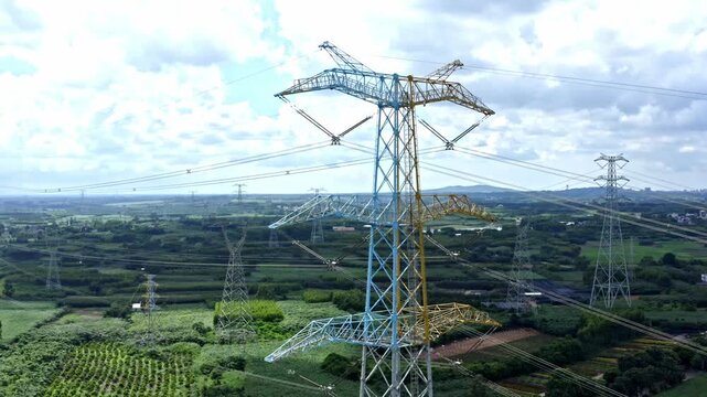Power Grid Transmission Towers Over Rice Paddies in Zhanjiang China Under Blue Sky