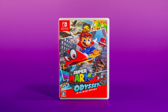 Fukuoka, Japan - november 5, 2025 : Super Mario Odyssey Nintendo Switch game cartridge isolated on purple gradient background