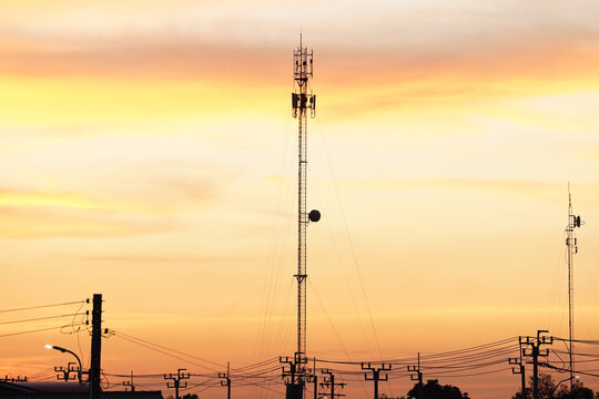 Cell tower communication antenna transmission network wireless signal technology sunset sky