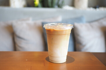 Iced coffee served in a clear cup at a cozy cafe setting
