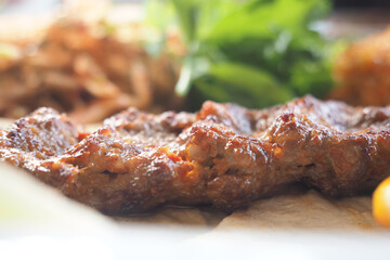 Delicious grilled meat served with fresh green garnish
